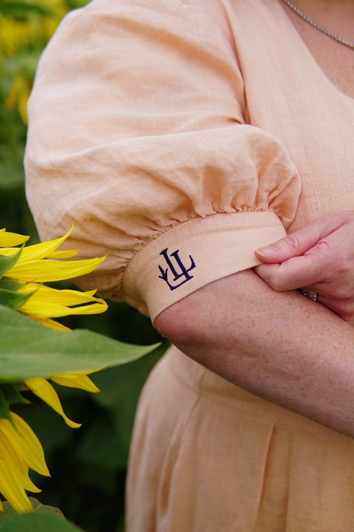The Lobster Bisque Dress, close-up of the embroidered LL crest on the sleeve cuff