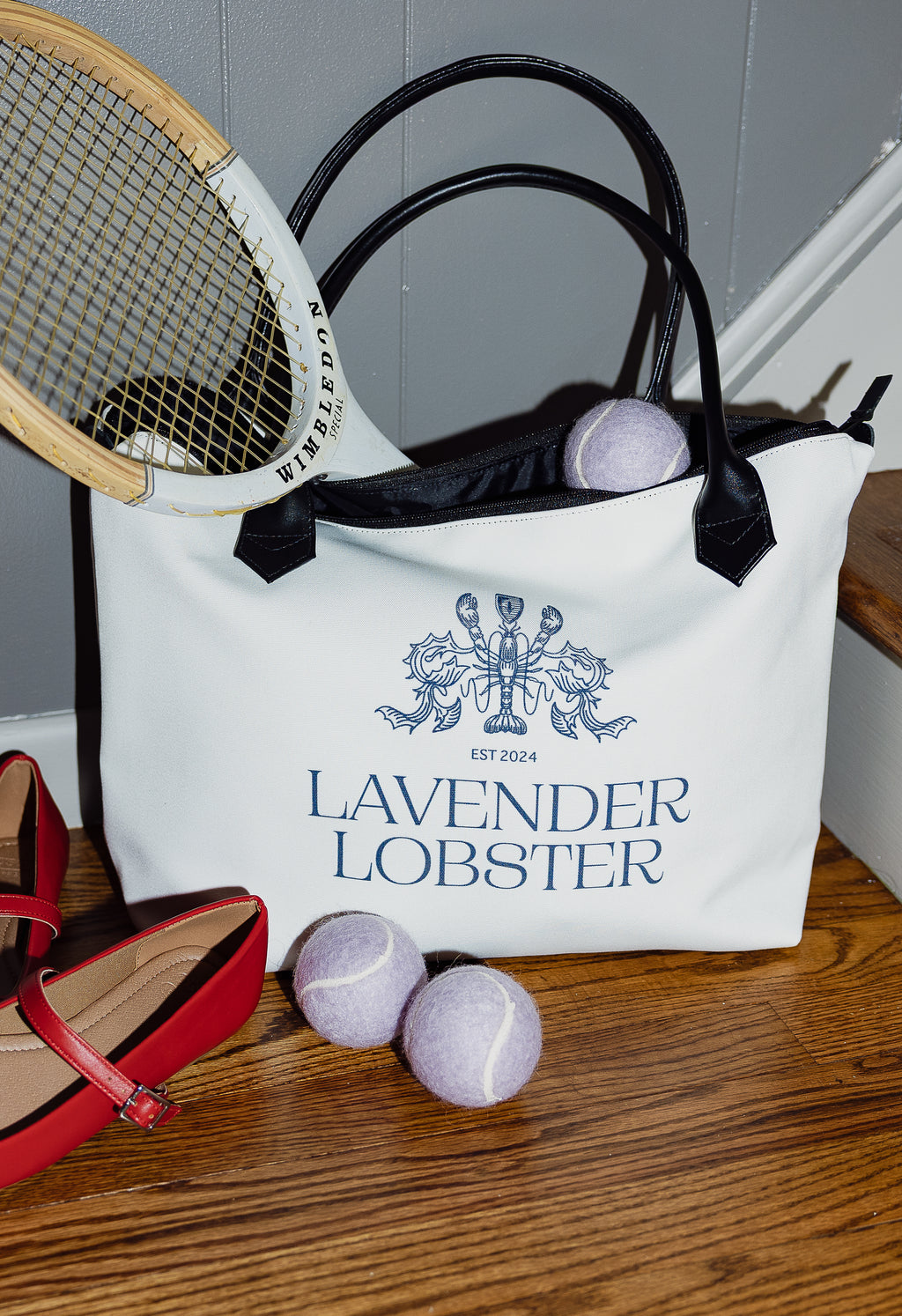The Lobster Boat Tote in woven canvas with crest embroidery, styled shot