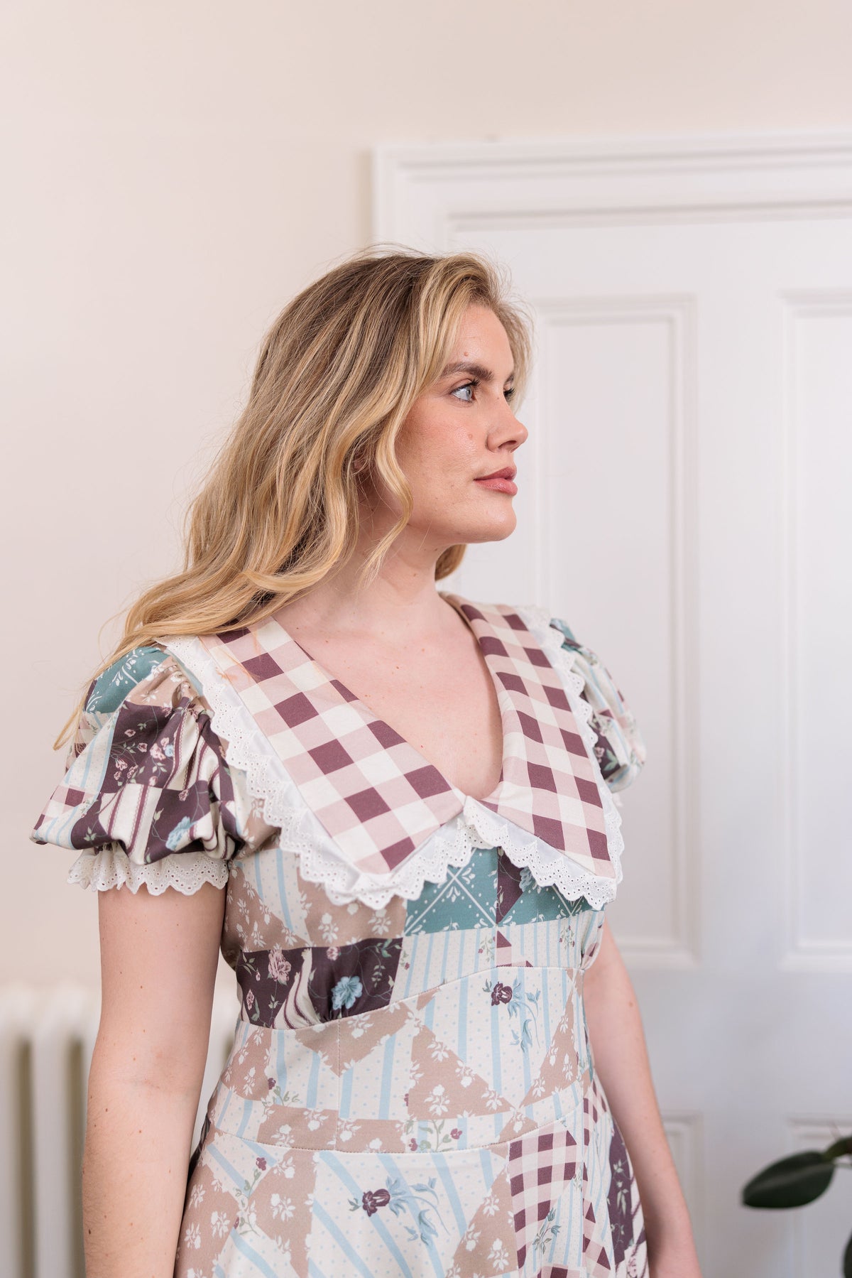 The Cottage Dress in organic cotton knit with a quilted countryside print and gingham collar, front view