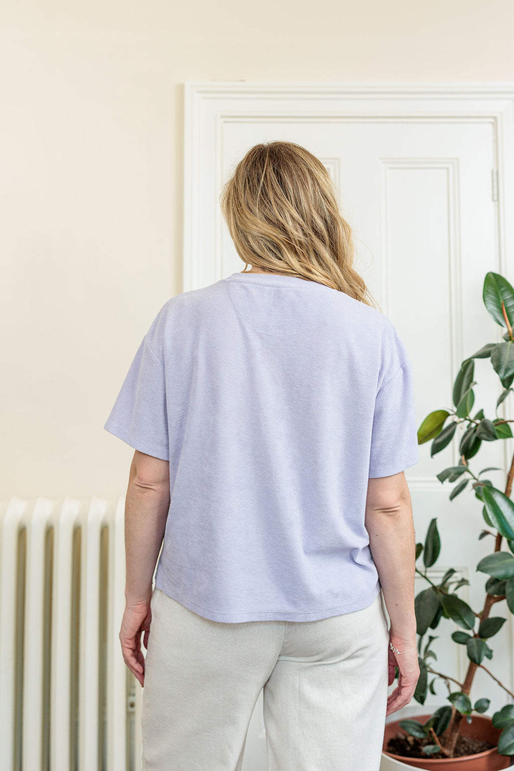 The Clubhouse Tee in organic combed cotton towelling with crest embroidery, worn outdoors