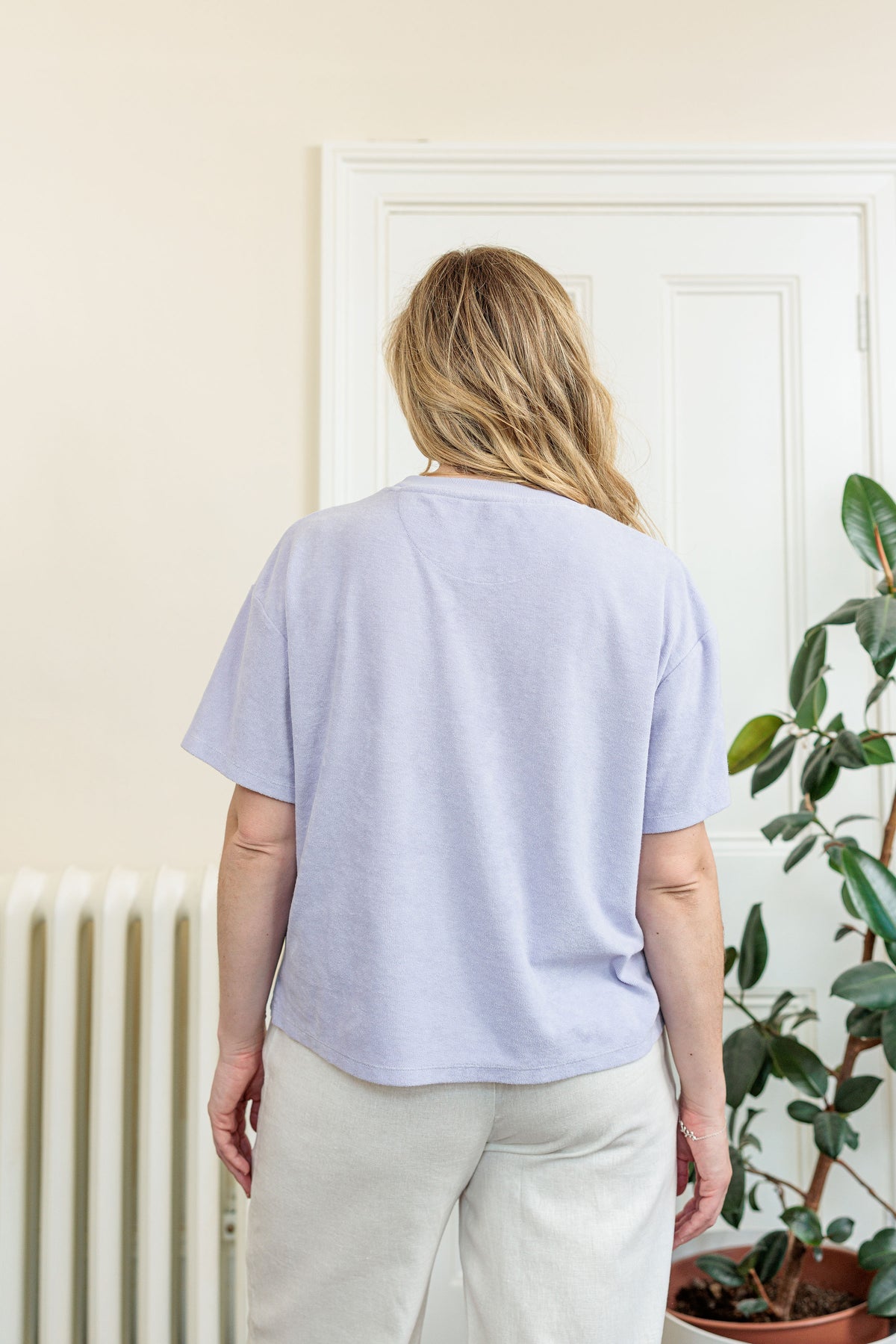 The Clubhouse Tee in organic combed cotton towelling with crest embroidery, worn outdoors