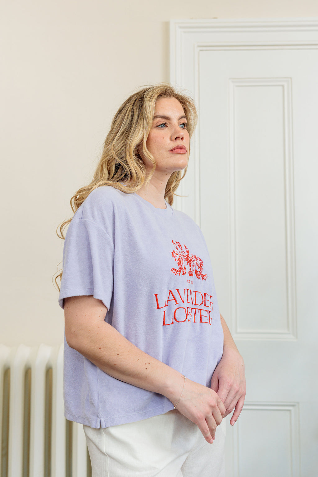 The Clubhouse Tee in organic combed cotton towelling with crest embroidery, close-up detail