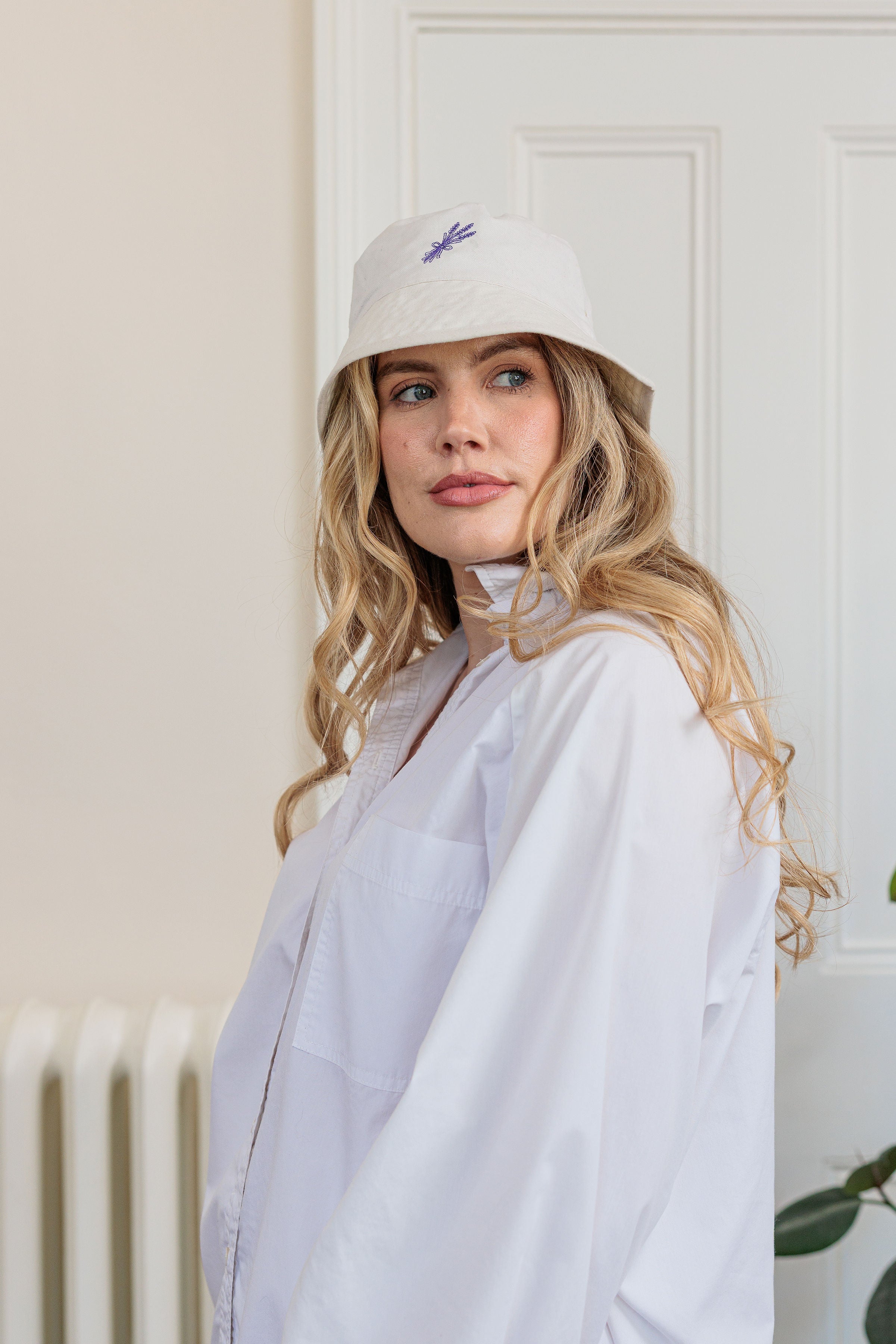 The Lavender Bouquet Bucket Hat with embroidered lavender bouquet detail, worn outdoors