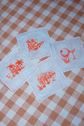 Clubhouse Cocktail Napkins, set of 4 in flax linen printed with yacht club scenes