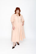 The Lobster Bisque Dress in Bisque pink organic linen, front view in studio