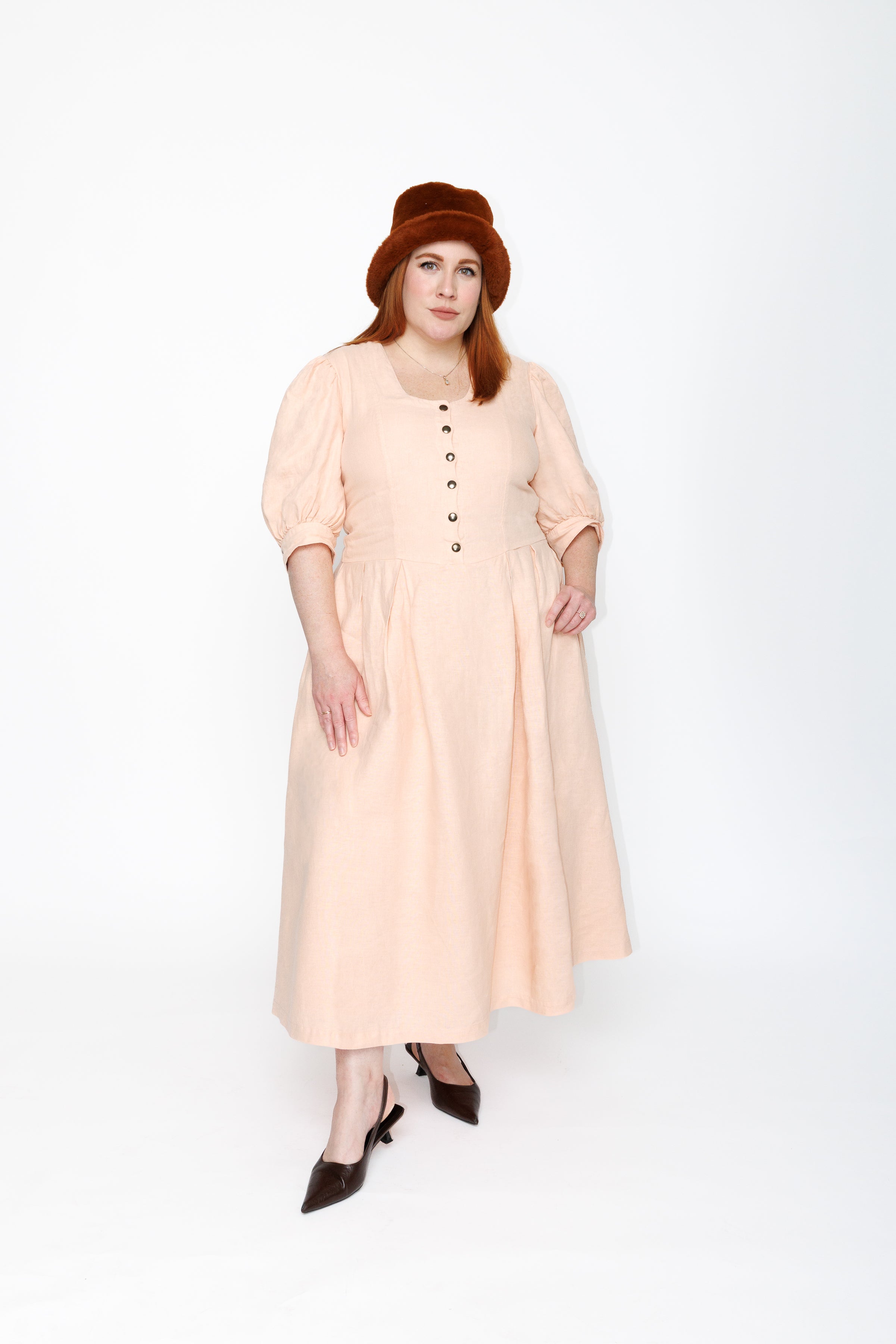 The Lobster Bisque Dress in Bisque pink organic linen, front view in studio