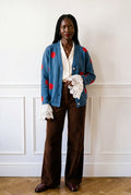 a polka dot merino wool cardigan with a lace wrist cuff by sustainable British fashion house Lavender Lobster